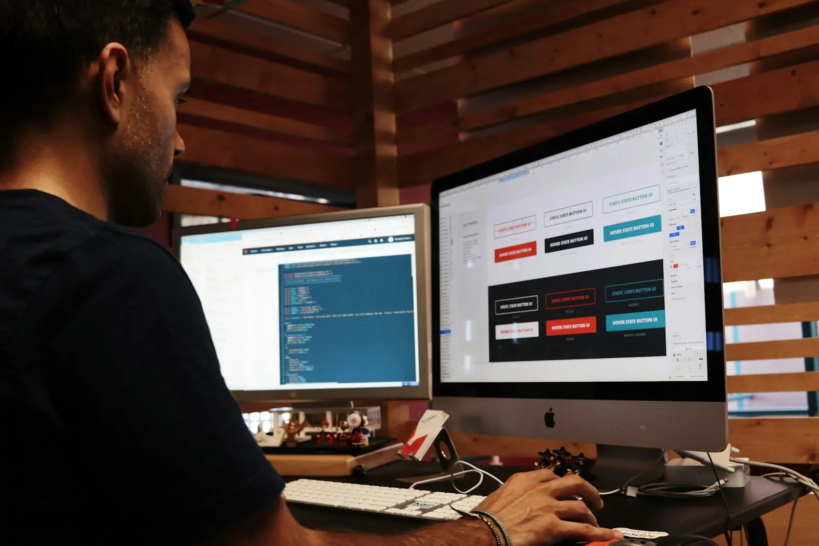 Developer working across two monitors